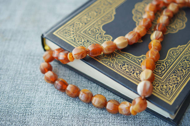 istock Holy book Quran and rosary on table, close up. 1483549478