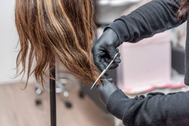 istock Haircutting Education - Hairstylist Explaining Haircutting Techniques 1483560495