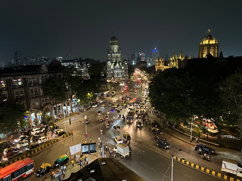 Vehicles in motion at night in front of Chhatrapati Shivaji Terminus in Mumbai, India