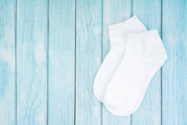 istock A White cotton socks for design on blue wooden background with copy-space. 1483564555