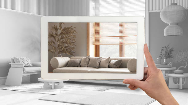 istock Augmented reality concept. Hand holding tablet with AR application used to simulate furniture products in custom architecture design, total white background, japandi living room 1483567325