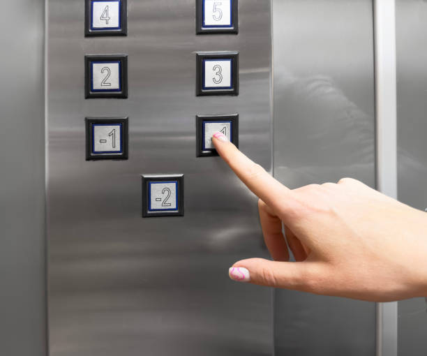 istock Woman hand pressing push button for elevator. Hand finger press the Elevator button. Woman using Elevator in office or apartment 1483567700