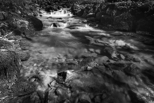 Black and white photo of the East Lyn river flowing through the Doone Valley at Watersmmeet in Devon