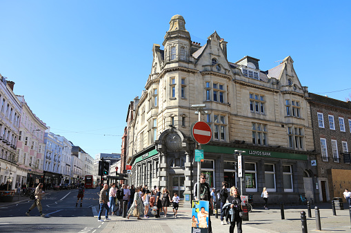 Brighton, United Kingdom - April 15, 2022: Locals and tourists are walking and shopping on the street enjoying the beautiful day and laid-back lifestyle in Brighton.