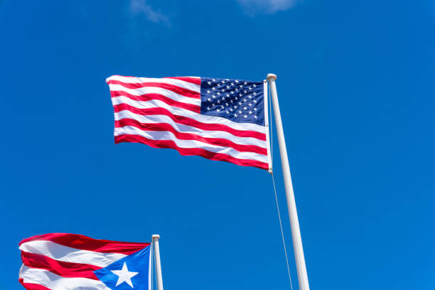 istock Puerto Rican and American Flags on a cloudless sky 1483571325