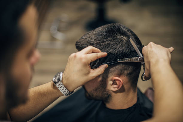 istock Barber cutting clients' hair 1483571334
