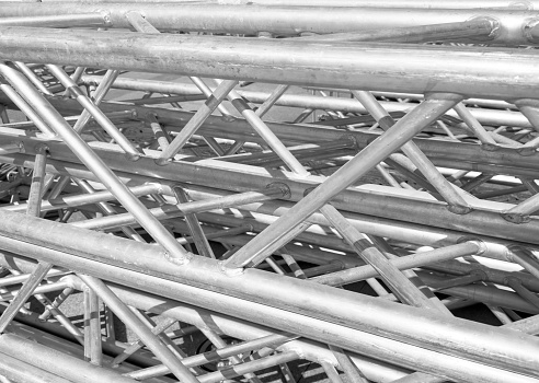 Aluminium profile manufacturing. Structural metal aluminium shapes. Aluminium profiles texture for constructions. Aluminium constructions factory background.