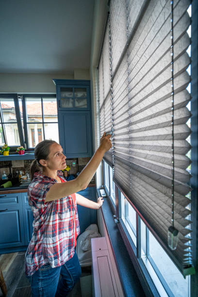 istock Woman opening the window shades. 1483571571