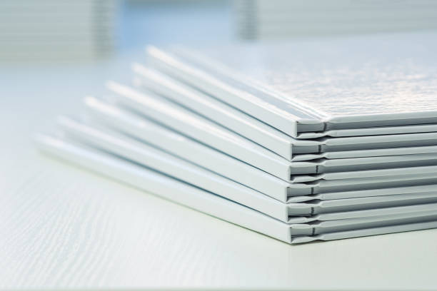 istock spines of photo books with clean empty white covers, close-up, partial blur 1483571621