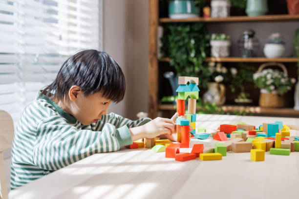 istock A happy little boy playing with building blocks at home 1483572061