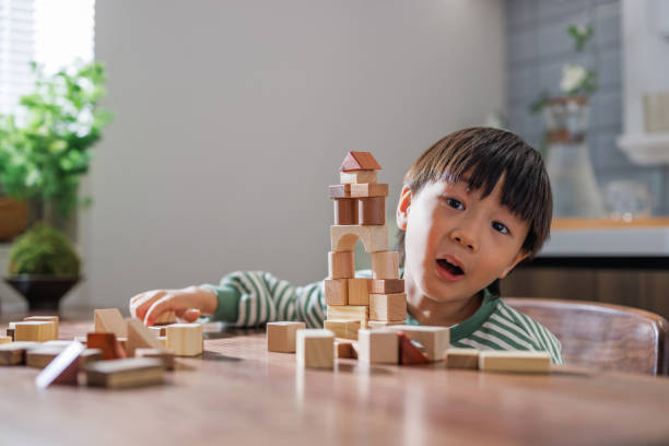 istock The mischievous boy is playing with building blocks at home 1483572961