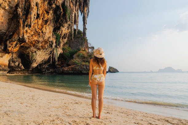 istock Woman walking on Railey beach and looking at stunning scenery 1483573280