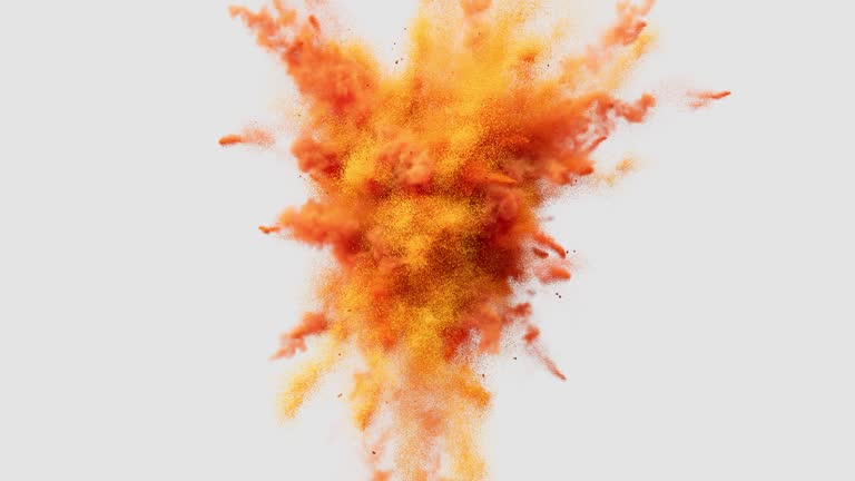 The orange powder explodes, filling the air with its vivid color