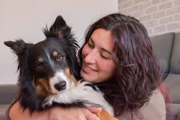 istock Young woman hugging her dog and smiling. 1483573972