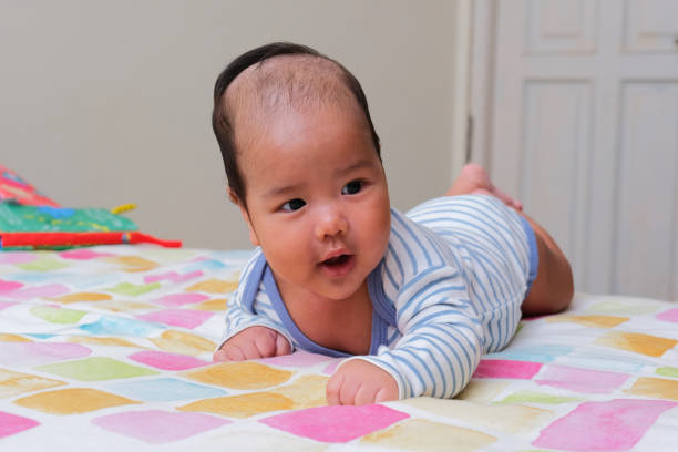 istock Asian infant showing happy face expression when doing tummy time 1483575916