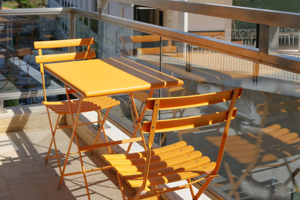istock yellow table and chairs on a sunny balcony terrace 1483576967