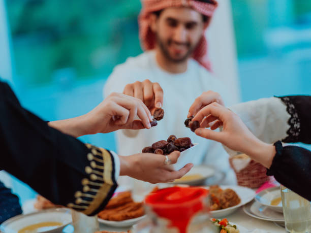 istock Modern multiethnic muslim family sharing a bowl of dates while enjoying iftar dinner together during a ramadan feast at home 1483580082
