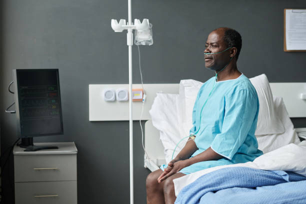 istock Elderly man with dropper sitting in ward 1483581442