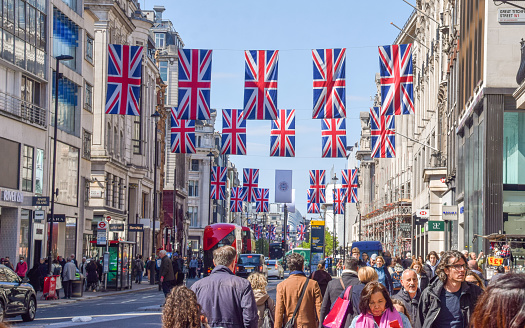London, UK - April 20 2023: Busy Oxford Street lined with Union Jack flags and banners ahead of the coronation of King Charles III.