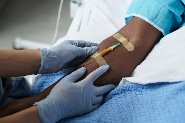 istock Nurse inserting catheter in arm of patient 1483583036