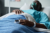 Senior man lying with oxygen mask in hospital