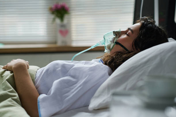 istock Young woman breathing with oxygen mask 1483583779