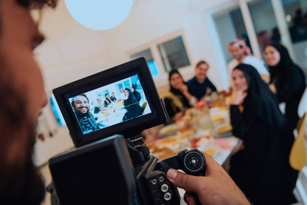 istock Professional videograph recording video while Muslim family having iftar together during Ramadan 1483592571