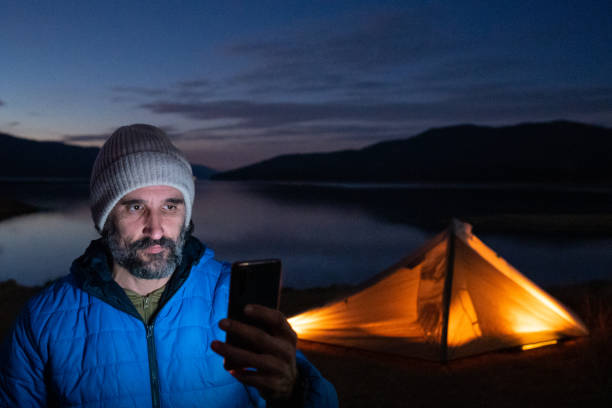 istock People in nature. Man selfie at camping on lake. 1483593281