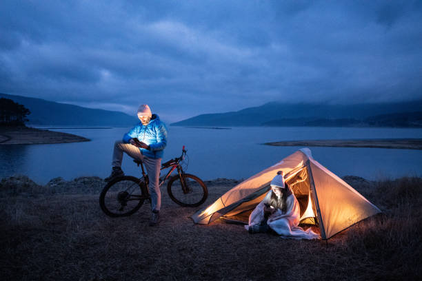 istock People in nature. Couple camping at lakeshore. 1483593285