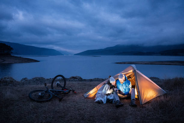 istock People in nature. Couple camping at lakeshore. 1483593287