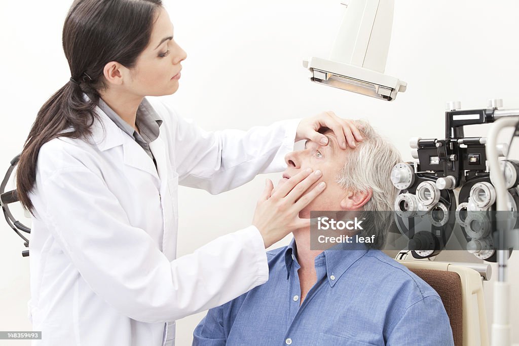 Eyesight Test Examination Optometrist taking an eyesight test examination. Eye Stock Photo