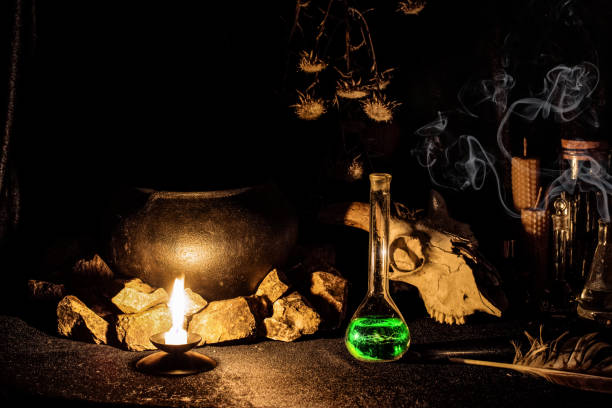 witchs altar with goats skull, burning candle, dry herbs and witchcraft potion in vessel in the dark, low key, selective focus. - witchs imagens e fotografias de stock