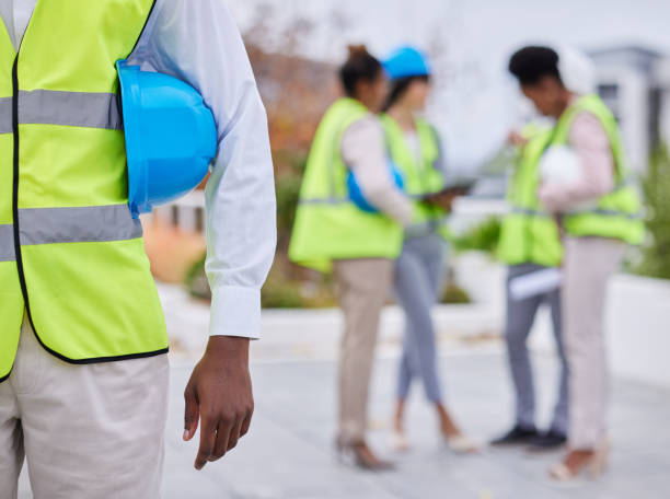 istock Construction worker team, man and helmet in mockup with planning vision, strategy or blueprint for property. Architect group, black woman and men with tablet, safety and collaboration for development 1483595962