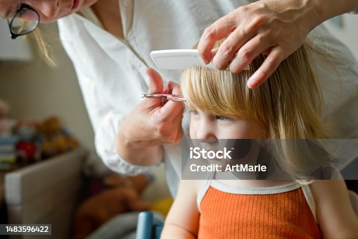 istock Cute blond child getting a haircut at home 1483596422