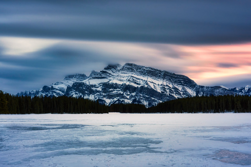 Beautiful view of Two Jack Lake with Mount Rundle in winter on the evening at Banff national park, Alberta, Canada. Long exposure effect