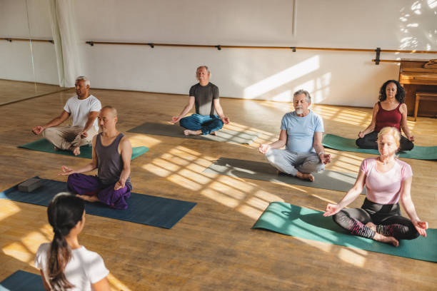 istock Multicultural Group Of Yoga Participants Seated While Meditating 1483599533