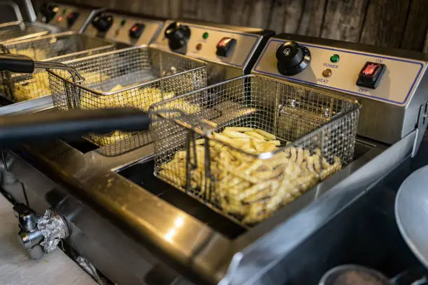 Fryer Baskets with french fries ready to go with on a christmas market stall. Depth of Field