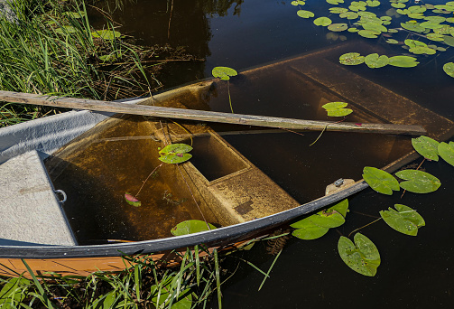 view of a rowboat that sank at a beach