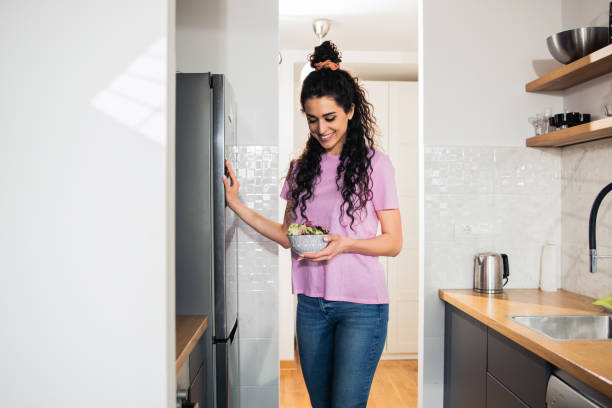istock Woman looking at food in refrigerator 1483607387
