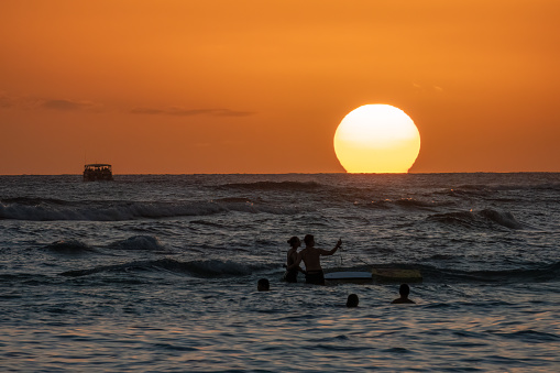 Sunset along the shores of Waikiki Beach, Honolulu, Oahu, Hawaii, USA