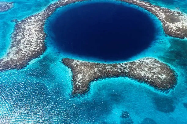 in the barrier reef in belize a cave in formed a great blue hole.