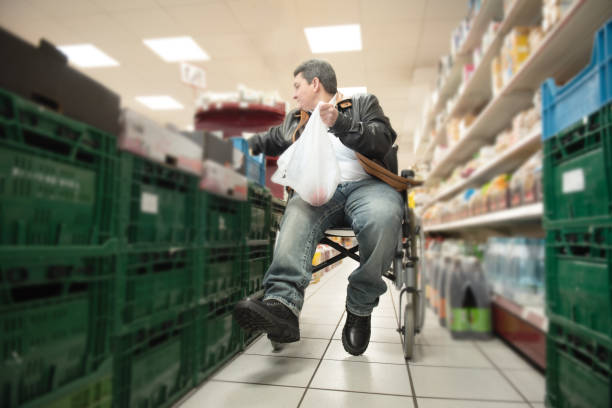 A disabled person in a wheelchair buys groceries stock photo