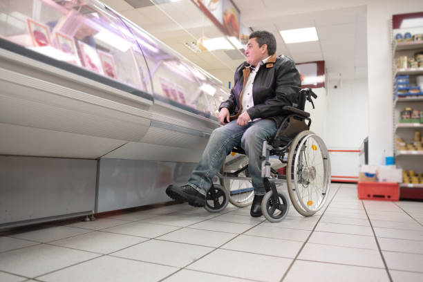 A disabled person in a wheelchair buys groceries stock photo