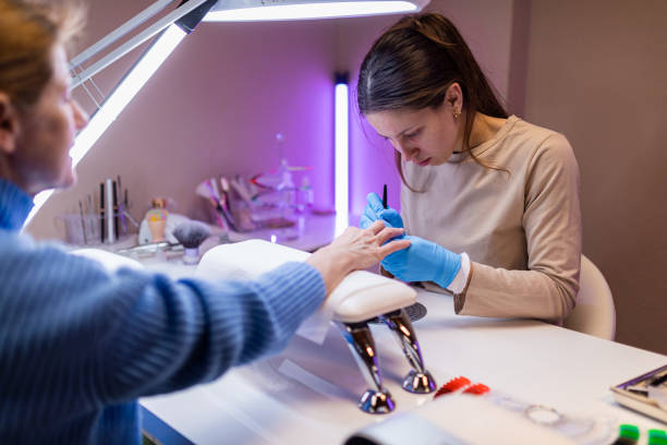 Woman getting manicure in nail salon