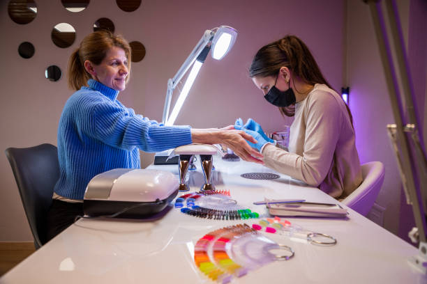 istock Woman getting manicure in nail salon 1483617674