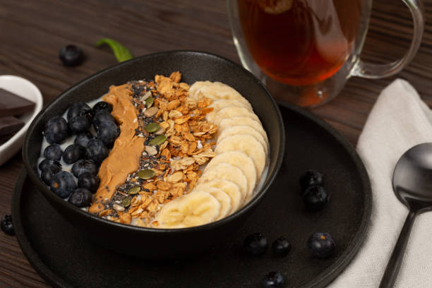 istock Oatmeal porridge with granola, seeds, peanut paste and berries 1483617747