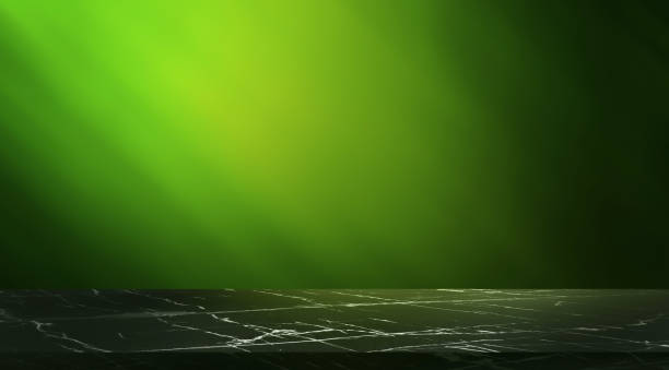 istock dark black polished marquina stone marble table at foreground on green blurred bright light background. empty table luxury table for product displayed. elegant scene for business advertising. 1483617860