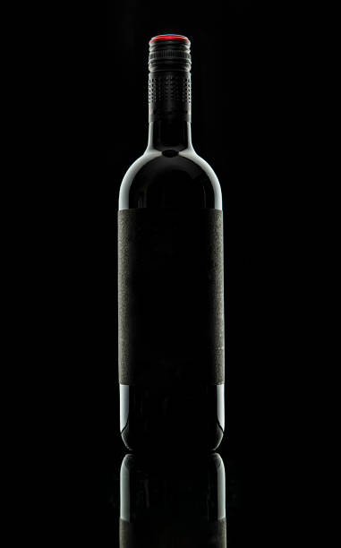 istock Bottle of red wine on black background 1483621008