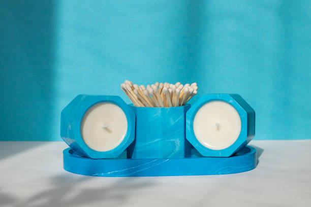 istock Handmade candlesticks made of acrylic with olive wax on a blue-white background. 1483623239