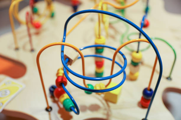 istock classic beads maze toy featuring colorful beads on wires, which kids can move around. Symbolizes early childhood development of motor skills and hand-eye coordination, as well as the concept of cause and effect 1483625665